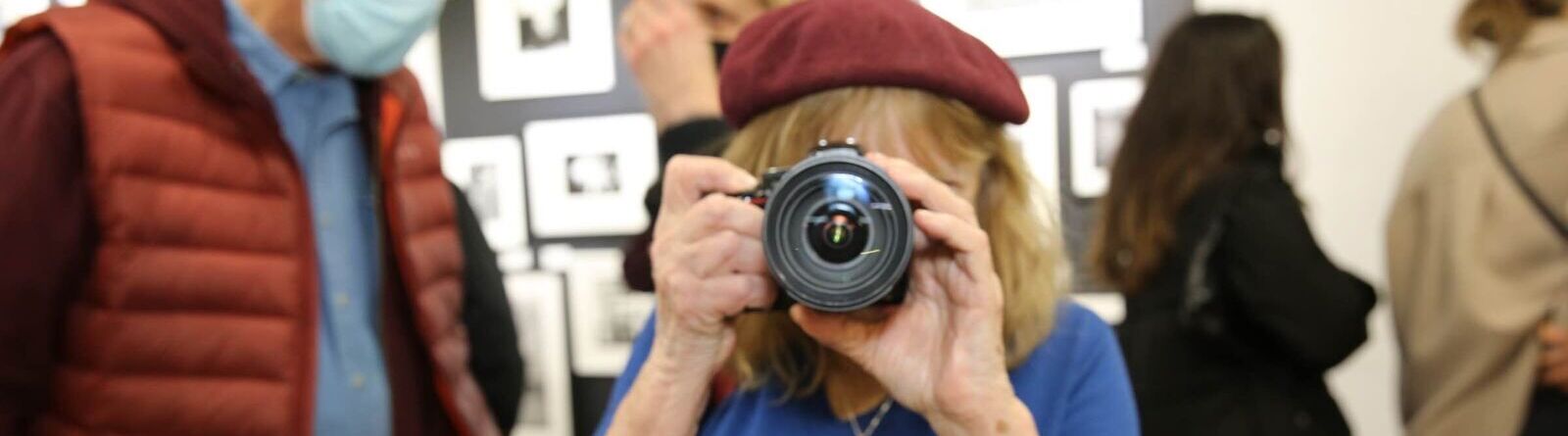 Woman looking through a camera