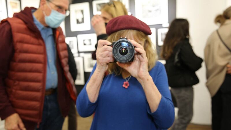 Woman looking through a camera